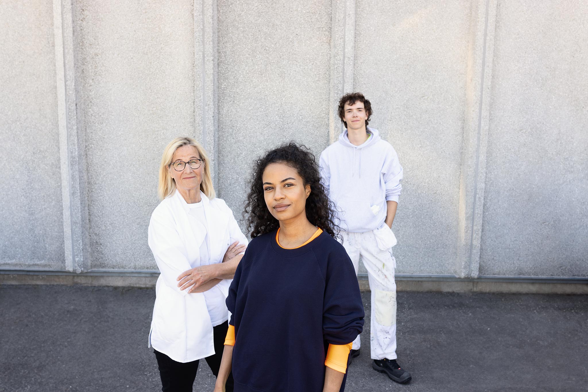 A food industry worker, an electrician, and a construction painter in a group photo.