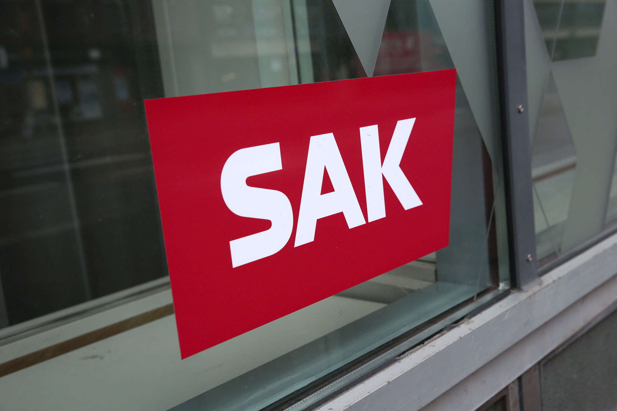 SAK logo sticker attached to a window.